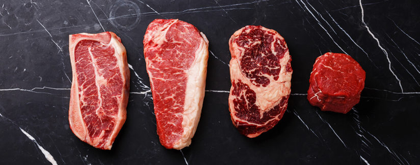 Four different types of aged steaks in a row